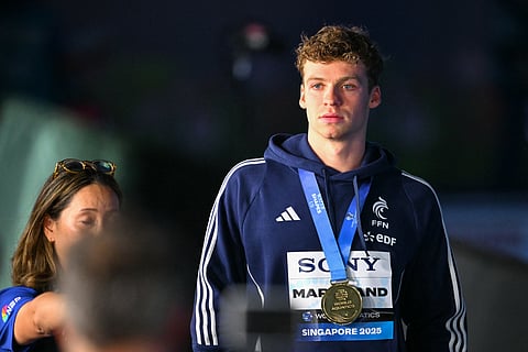 Gold medallist France's swimmer Leon Marchand celebrates on the podium of the men's 200m individual medley swimming event during the 2025 World Aquatics Championships in Singapore on July 31, 2025.