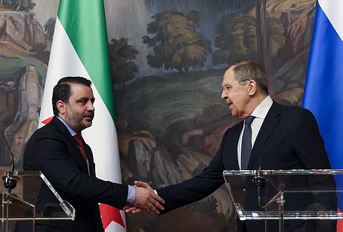 Russian Foreign Minister Sergei Lavrov and Syrian Foreign Minister Asaad Al Shaibani shake hands at the end of a joint press conference following their meeting in Moscow on July 31, 2025.