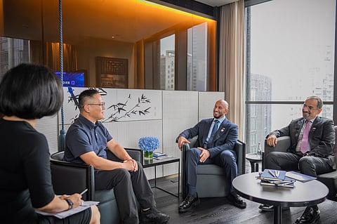 Abdulla bin Mohammed bin Butti Al Hamed, Chairman of the National Media Office (2nd from R) during meeting in Shanghai