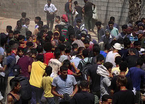 Palestinians rush to collect humanitarian aid airdropped into Zawaida in central Gaza Strip.