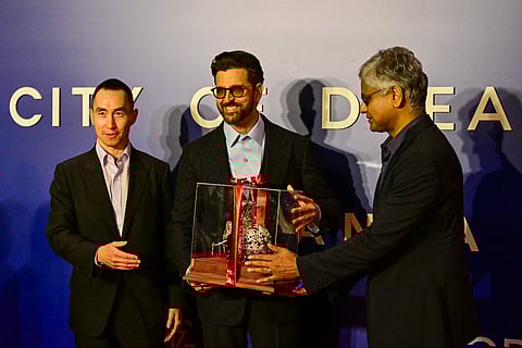 Hrithik Roshan (C) receives a present from Chairman of John Keells Holdings, Krishan Balendra (R) and CEO of Melco Resorts & Entertainment, Lawrence Ho (L) during opening ceremony of ‘City of Dreams’ in Colombo on August 2, 2025.