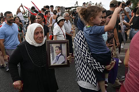 Lebanese demonstrators march during a gathering to honour the victims of the catastrophic port explosion in 2020 and to call for accountability for the blast, in Beirut on August 4, 2025.