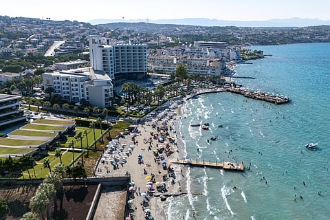 This aerial photograph shows bathers enjoying in the sea in front of a hotel in Cesme, in the Turkey west province of Izmir, on July 30, 2025.