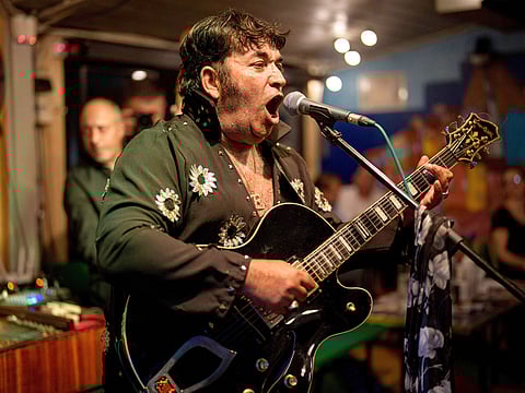 Tudor Lakatos, who goes by the stage name Elvis Rromano, performs with the Taraful Frunzelor band, at the Terasa Florilor restaurant, in Bucharest, Romania, on June 20, 2025.