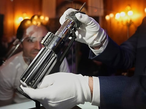 Darth Vader's primary duelling lightsaber, used in Star Wars films The Empire Strikes Back (1980), and Return of the Jedi (1983), on display at a pre-auction viewing in London.