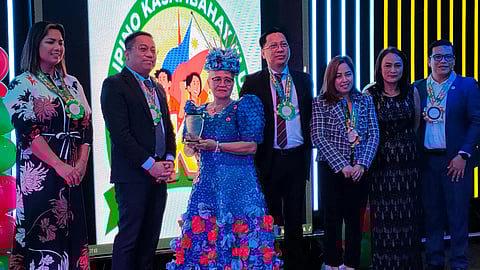 Marissa Postre receives a trophy from Philippine Consul General Marford Angeles during the Gawad Kasambahay, an award-giving body that honors and celebrates the invaluable contributions of household workers, including those in Dubai.