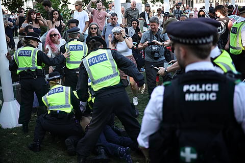 A protester is arrested by police officers at a "Lift The Ban" demonstration in support of the proscribed group Palestine Action, calling for the recently imposed ban to be lifted, in Parliament Square, central London, on August 9, 2025.