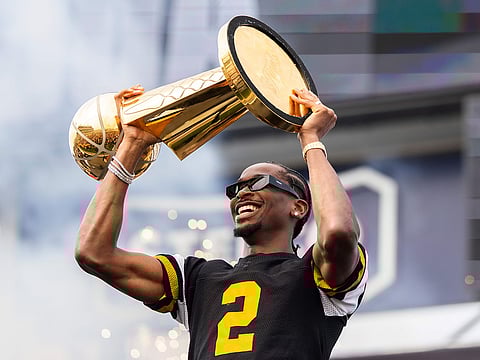 Oklahoma City Thunder's Shai Gilgeous-Alexander holds up the Larry O'Brien Trophy during a ceremony honoring the NBA basketball champion.