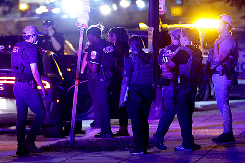 Federal and local law enforcement officers investigate a suspect’s vehicle on South Capitol Street on August 11, 2025 in Washington, DC.