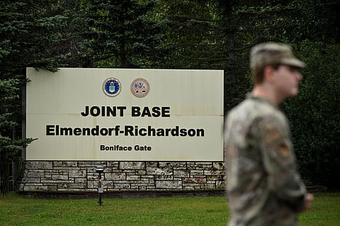A member of the military stands outside an entrance to Joint Base Elmendorf-Richardson in Anchorage, Alaska, on August 14, 2025, ahead of the August 15 scheduled meeting between US President Donald Trump and Russian President Vladimir Putin.