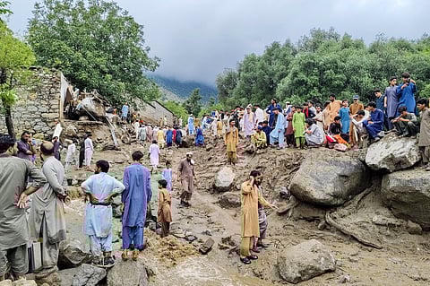 People gathered at the site of a flashflood in Salarzai Tehsil of Pakistan's Bajaur district on August 15, 2025.