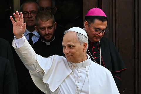 Pope Leo XIV waves to the crowd as he exits the Parrocchia Pontificia di San Tommaso da Villanova (Papal Parish of St. Thomas of Villanova) after leading the Assumption Day Mass at the summer papal estate in Castel Gandolfo, southeast of Rome on August 15, 2025.