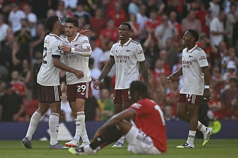 Arsenal players celebrate on the final whistle of the English Premier League match against Arsenal at Old Trafford on Sunday.