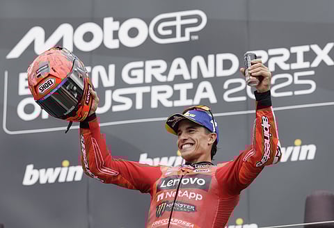 Winner Ducati Lenovo team's Spanish rider Marc Marquez celebrates on the podium after the Austrian MotoGP Grand Prix at the Red Bull Ring race track in Spielberg, Austria, on August 17, 2025.