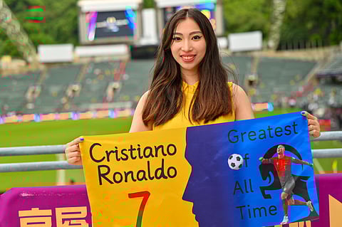A supporter of Al Nassr's Cristiano Ronaldo poses before the Saudi Super Cup semi-final football match between Al Nassr and Al Ittihad at the Hong Kong Stadium in Hong Kong on August 19, 2025.