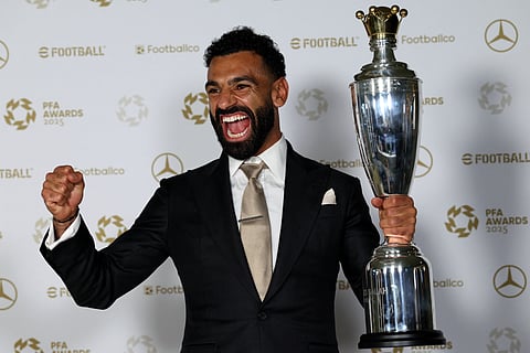 Liverpool's Egyptian striker Mohamed Salah celebrates with the Men's PFA Players' Player of the Year award at the Opera House in Manchester on Tuesday.