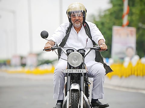 karnataka Deputy Chief Minister DK Shivakumar rides a bike after the inauguration of the flyover at Hebbal Junction, in Bengaluru.