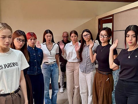 BINI said an edited clip of them trying Filipino street food sparked online hate and emotional distress.