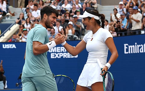 Britain's Emma Raducanu and Carlos Alcaraz of Spain celebrate during their first round mixed doubles match against Jessica Pegula of the US and Jack Draper of Britain at the US Open tennis tournament in New York City on August 19, 2025.
