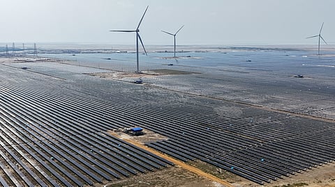 This aerial photograph taken on October 15, 2024, shows wind turbines and solar panels installed at the Adani Green Renewable Energy Plant in Khavda, in India's Gujarat state.