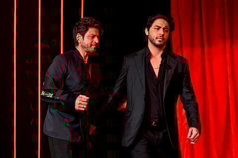 Bollywood actor Shah Rukh Khan (L) and his son Aryan Khan arrive to attend the preview of his son's directorial debut, Netflix's series 'The Ba***ds of Bollywood’, in Mumbai on August 20, 2025.