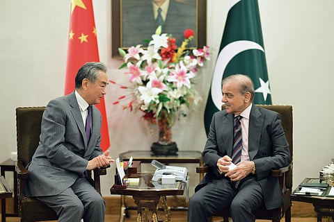 This handout photograph taken and released by Pakistan's Prime Minister Office on August 21, 2025 shows Pakistan's Prime Minister Shehbaz Sharif (R) speaking with Chinese Foreign Minister Wang Yi at the Prime Minister House in Islamabad.