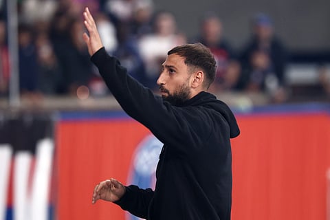 Paris Saint-Germain's Italian goalkeeper Gianluigi Donnarumma cheers supporters after the French L1 football match against Angers SCO at the Parc des Princes Stadium in Paris on August 22, 2025.