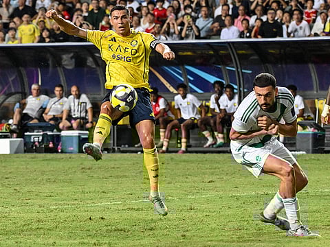 Al Nassr's Cristiano Ronaldo (L) vies for the ball during the Saudi Super Cup final football match against Al Ahli at the Hong Kong Stadium in Hong Kong on August 23, 2025.