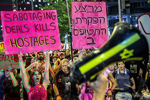 Protesters gather for a demonstration organised by the families of the Israeli hostages taken captive in the Gaza Strip since the October 2023 calling for action to secure their release and a ceasefire in the war against Hamas, outside the Defence Ministry headquarters in Tel Aviv, on August 23, 2025.