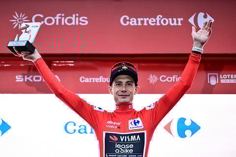 Team Visma-Lease a bike's Danish rider Jonas Vingegaard, wearing the overall leader's red jersey, celebrates on the podium after winning the second stage of the Vuelta a Espana, a 159,6 km race between Alba and Limone Piemonte, in Italy's Piemonte region, on August 24, 2025.