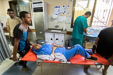 A medic injured in Israeli strikes on Nasser hospital in Khan Yunis in the southern Gaza Strip on August 25, 2025.