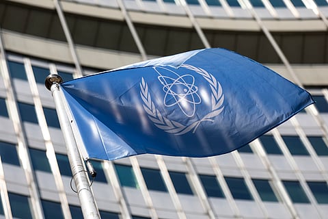 A flag if the International Atomic Energy Agency (IAEA) waves at the entrance of the Vienna International Centre.