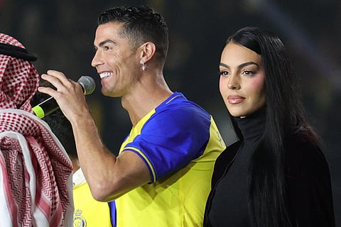 Al-Nassr's new Portuguese forward Cristiano Ronaldo (C), his partner Georgina Rodriguez (2nd-L) and his children stand on the stage during his unveiling at the Mrsool Park Stadium in the Saudi capital Riyadh on January 3, 2023.
