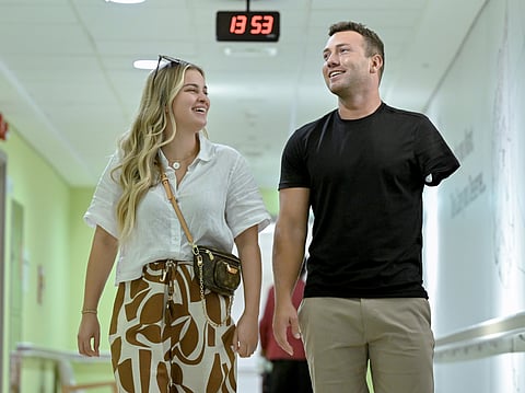 Joshua Arnold with his fianceee Alyssa Acker in Abu Dhabi, following his life-changing surgery.