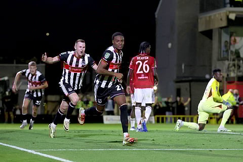 Grimsby Town's Tyrell Warren, center, celebrates scoring their side's second goal during an English League Cup second round soccer match against Manchester United, Wednesday, Aug. 27, 2025, at Hill Blundell Park in Grimsby, England.
