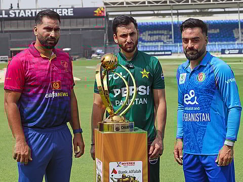 From left: Muhammad Waseem (UAE), Salman Agha (Pakistan) and Rashid Khan (Afghanistan) during the unveiling of the tri-series trophy at Sharjah Stadium on Thursday.