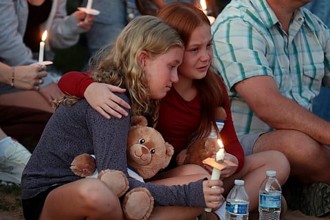 People gather at a vigil at Lynnhurst Park after a shooting at the Annunciation Catholic School, Wednesday, Aug. 27, 2025, in Minneapolis.