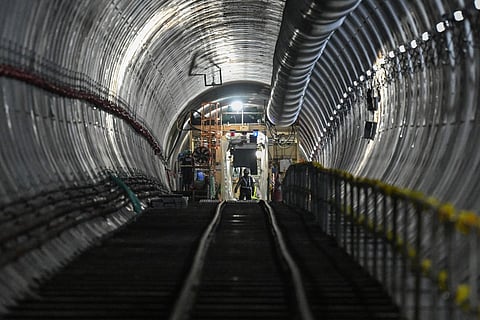 Workers walk along a tunnel of the under-construction Metro Manila Subway Project (MMSP) during an inspection in Quezon City. File photo taken on August 28, 2025.