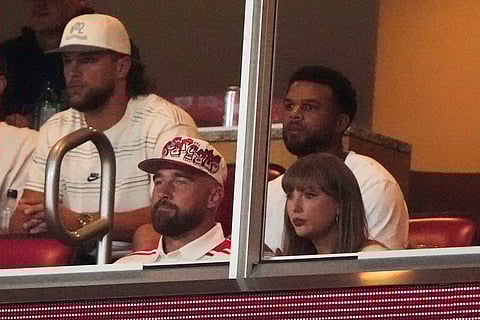 Taylor Swift, front right, sits with fiance Travis Kelce, second from front left, as they watch the first half of an NCAA college football game between Cincinnati and Nebraska, Thursday, Aug. 28, 2025, at Arrowhead Stadium in Kansas City, Mo. (AP Photo/Charlie Riedel)