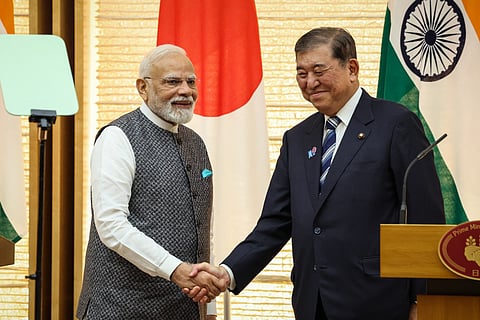 India's Prime Minister Narendra Modi (L) and Japan's Prime Minister Shigeru Ishiba shake hands during a joint press conference in Tokyo on August 29, 2025.