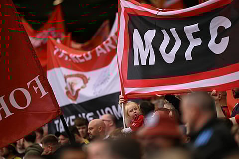 Manchester United fans are seen in the crowd during the English Premier League football match between Manchester United and Burnley at Old Trafford in Manchester, north west England, on August 30, 2025.