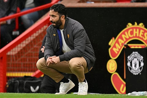 Manchester United's Portuguese head coach Ruben Amorim crouches on the touchline during the English Premier League football match between Manchester United and Burnley at Old Trafford in Manchester, north west England, on August 30, 2025.
