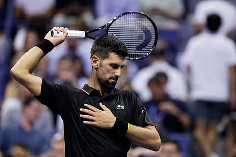 Novak Djokovic, of Serbia, stretches against Cameron Norrie, of Great Britain, during the third round of the U.S . Open tennis championships.