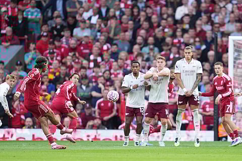 Liverpool's Dominik Szoboszlai (left) shoots to score his sides first goal during the English Premier League match against Arsenal in Liverpool, England, on August 31, 2025.