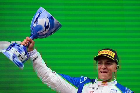 Third-placed RB's French driver Isack Hadjar celebrates on the podium following the Formula One Dutch Grand Prix at The Circuit Zandvoort, western Netherlands, on August 31, 2025.