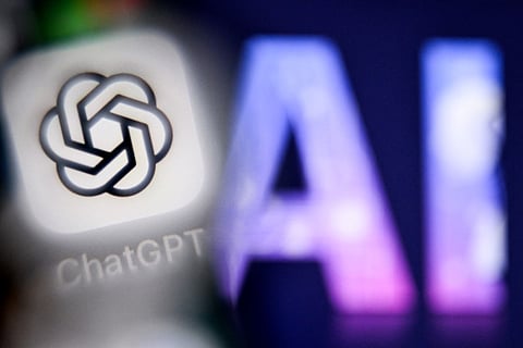 A photo taken on September 1, 2025 shows the letters AI for Artificial Intelligence on a laptop screen (R) next to the logo of the ChatGPT application on a smartphone screen in Frankfurt am Main, western Germany.