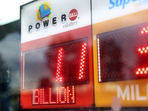 A sign displays a $1.1 billion Powerball jackpot as people line up to buy tickets ahead of the Labor Day drawing at Bluebird Store in Hawthorne, California, on September 1, 2025.