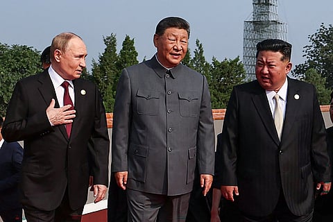 Russia's President Vladimir Putin walks with China's President Xi Jinping and North Korea's leader Kim Jong Un.
