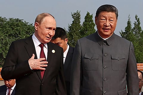 Russia's President Vladimir Putin (L) walks with China's President Xi Jinping before a military parade.