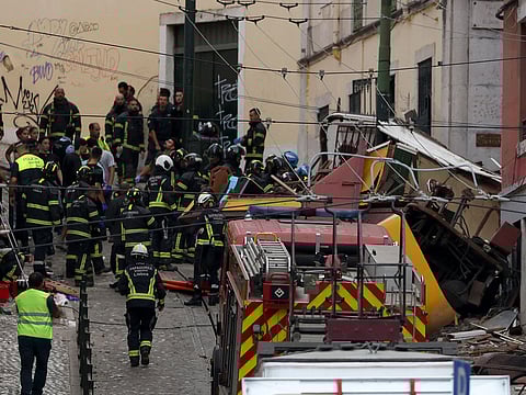 Police and firefighters work on the site of a funicular railway accident in Lisbon.